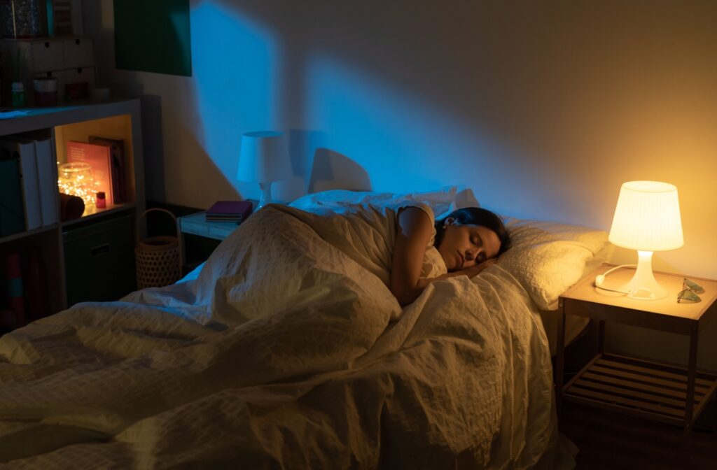 A person sleeping comfortably in a dimly lit room