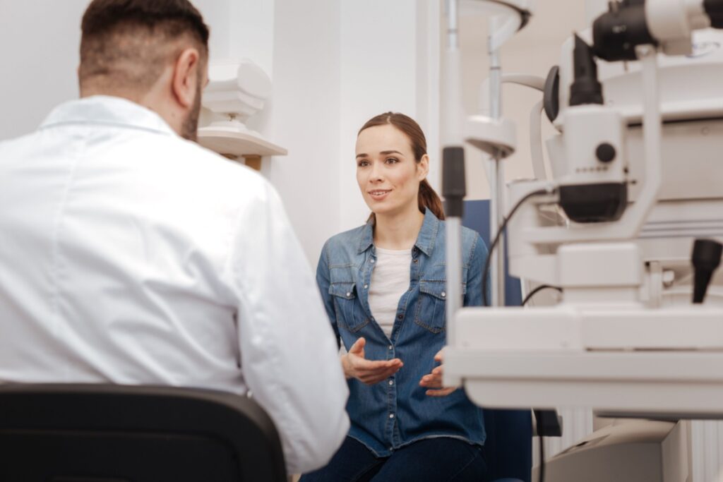 A person talking to their eye doctor about dry eye treatment during a routine comprehensive eye exam
